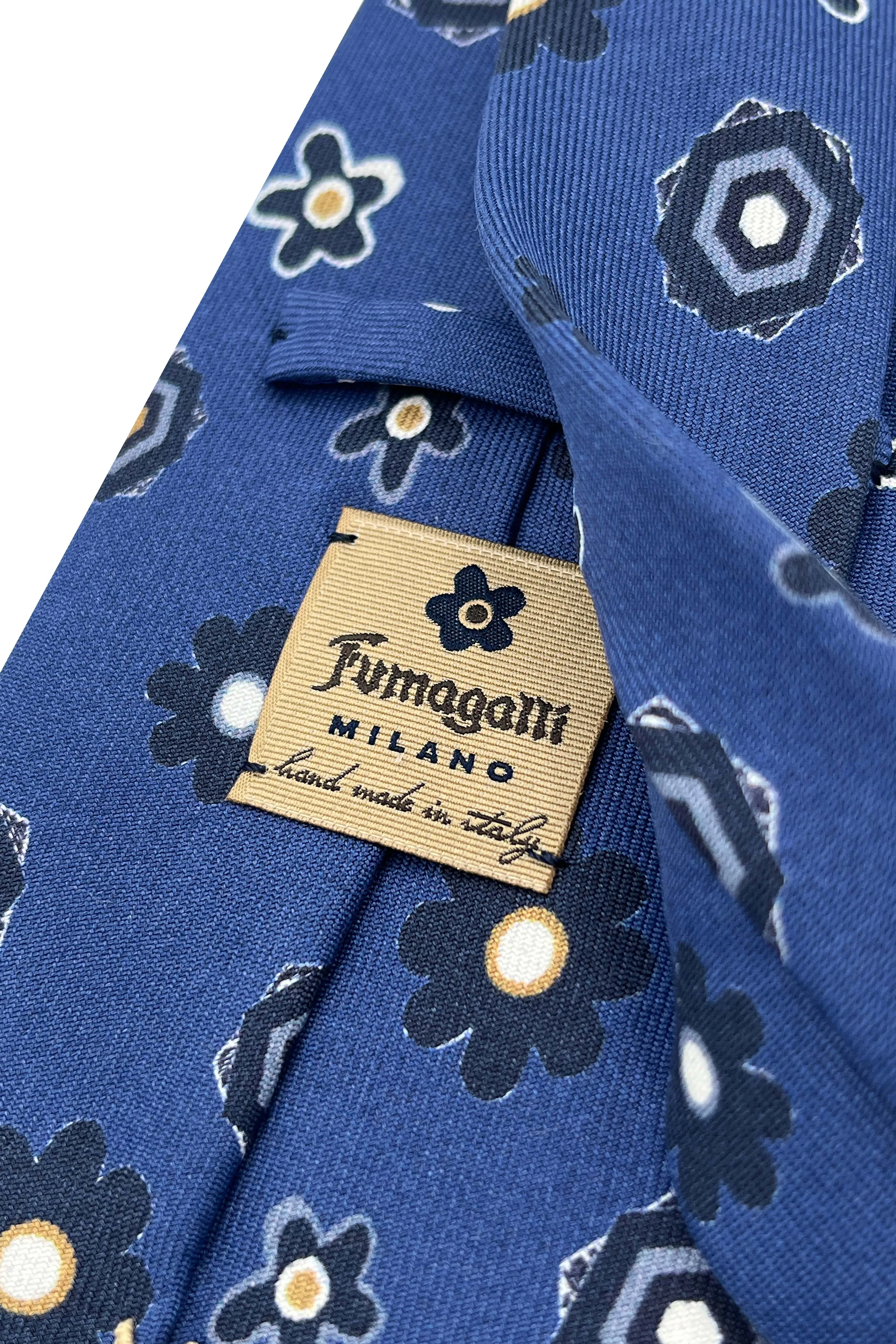 Blue tie in pure silk printed with blue flowers and geometrical design