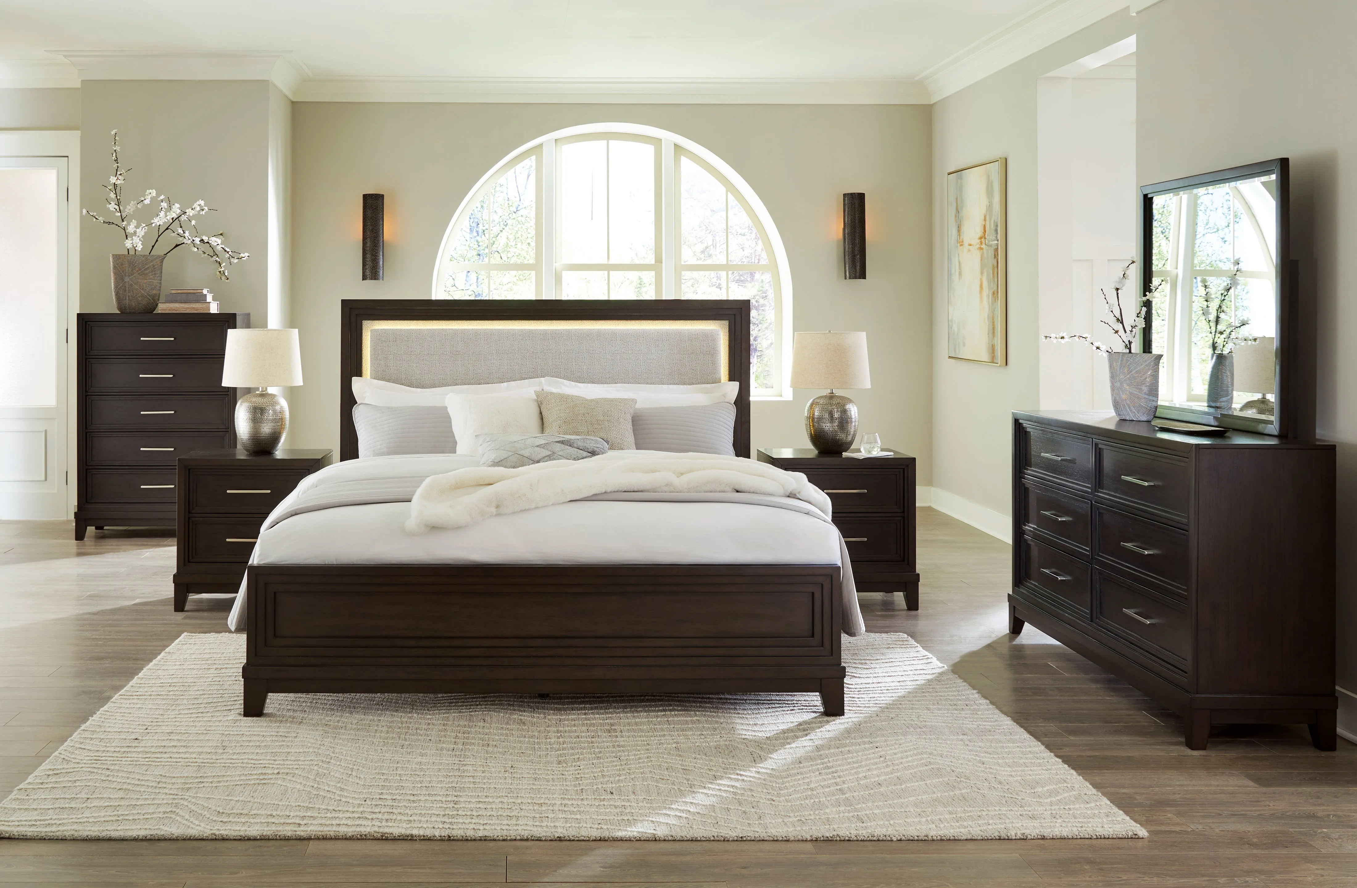 Neymorton California King Upholstered Panel Bed with Mirrored Dresser and Chest in Dark Grayish Brown